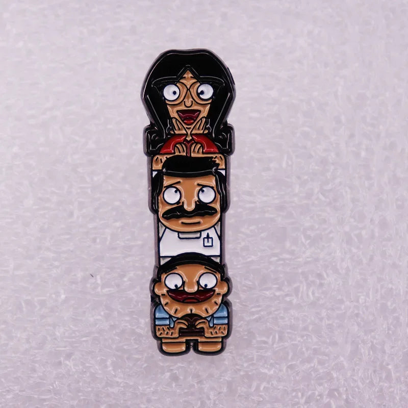An enamel pin badge featuring a stack of three cartoon characters with exaggerated expressions.