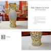 A gold-plated ceramic tabletop vase with a textured surface is displayed on a light background.