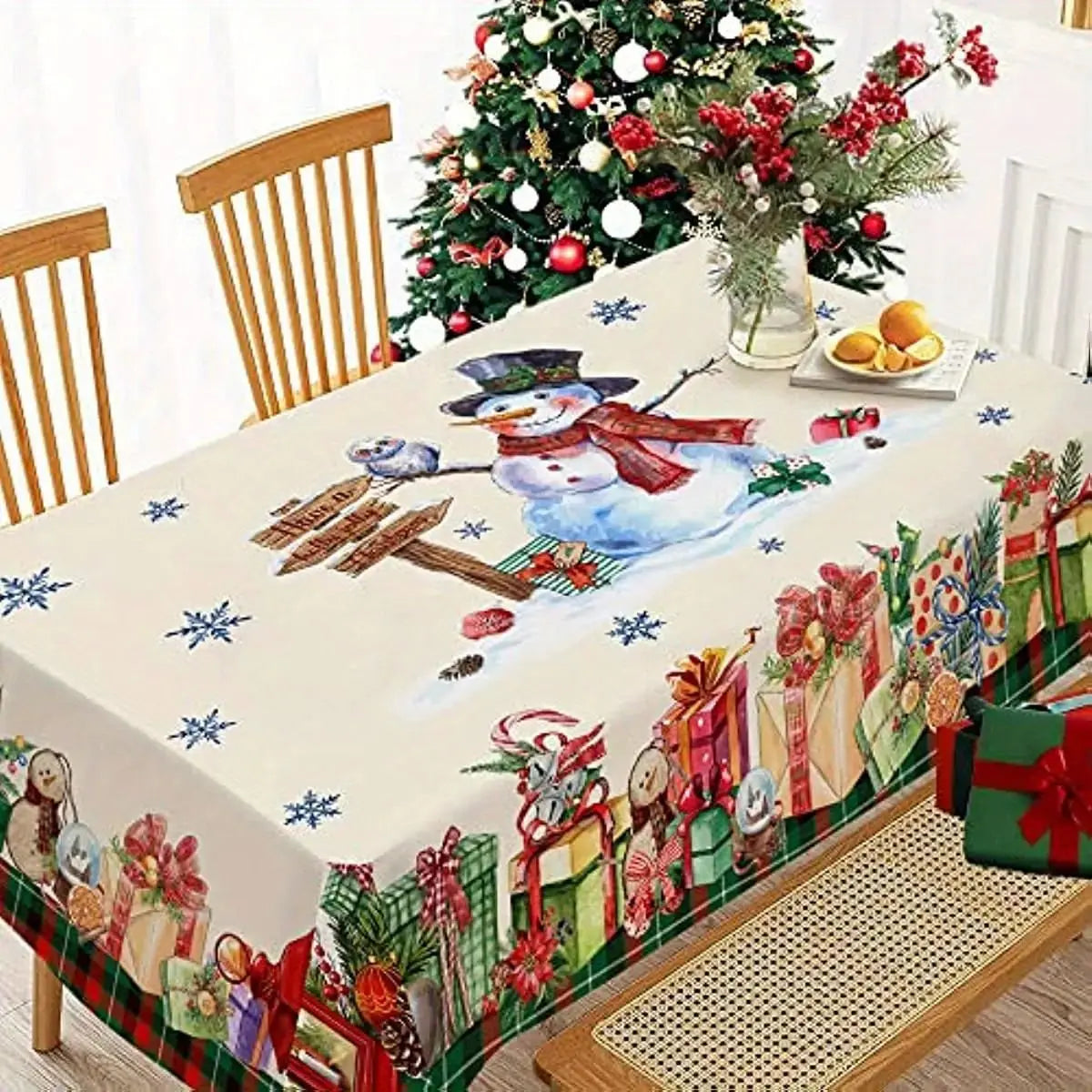 Festive red Christmas tablecloth featuring a snowman design and holiday decorations on a dining table.