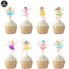 A set of eight fairy-themed cupcake toppers featuring various colors and designs on white frosting.