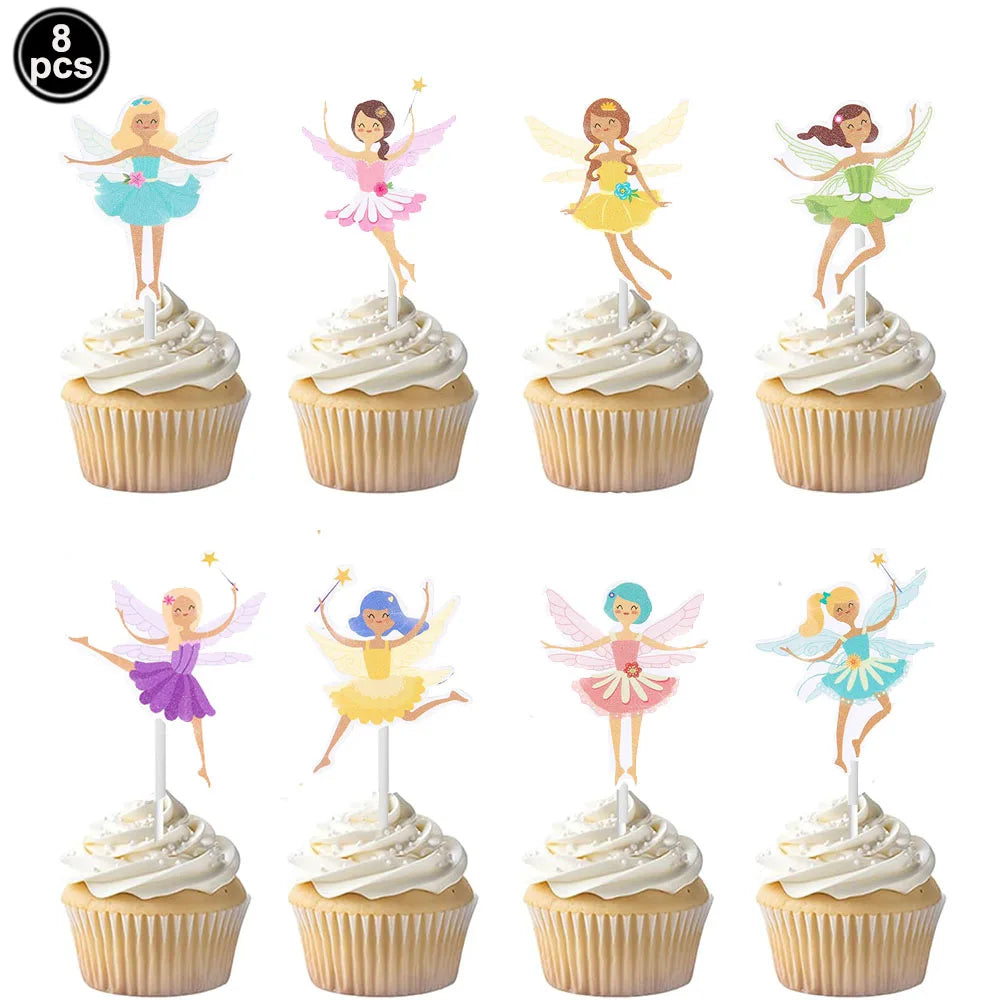 A set of eight fairy-themed cupcake toppers featuring various colors and designs on white frosting.