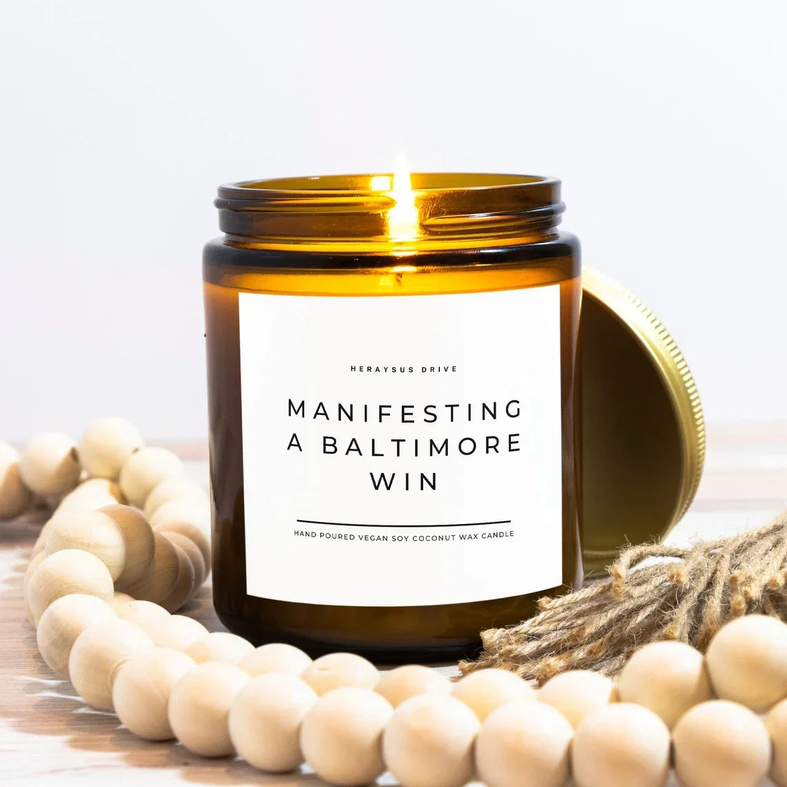 Amber glass candle jars with airtight metal lids and a bundle of natural wood beads