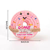 Handmade crochet donut shaped plush toy in pink with sprinkles and an inspirational slogan tag