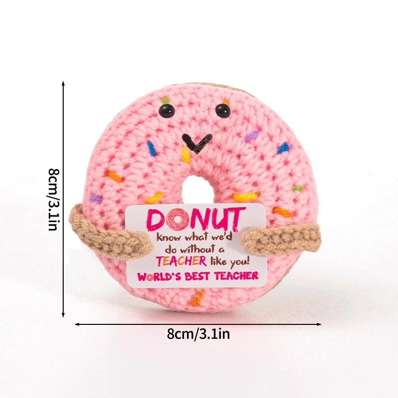 Handmade crochet donut shaped plush toy in pink with sprinkles and an inspirational slogan tag