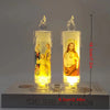 A pair of flameless LED religious prayer candles featuring figures of Jesus and Mary on a clear glass base.