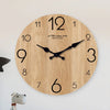 A round wooden wall clock with black hands and numbers, featuring visible wood grain texture.