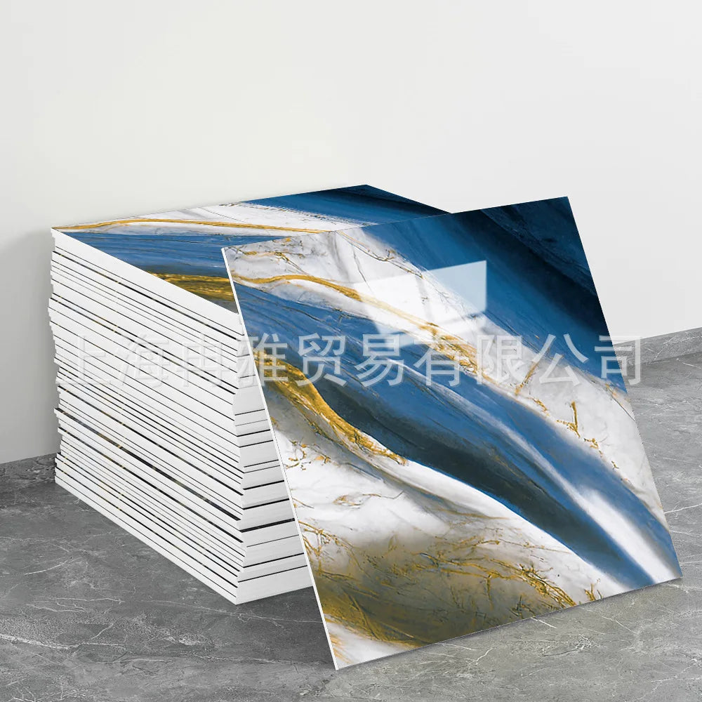 A stack of faux marble 3D self-adhesive wall tiles featuring blue, white, and gold marbled patterns.