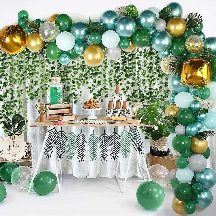 Artificial ivy vine garland featuring round green and gold ornaments decorating a display backdrop.