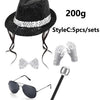 A black sequin disco hat, bow, and glove set with a silver wand and sunglasses.