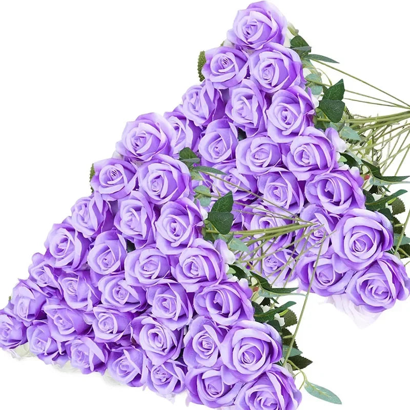 A bouquet of purple velvet artificial roses with green leaves.