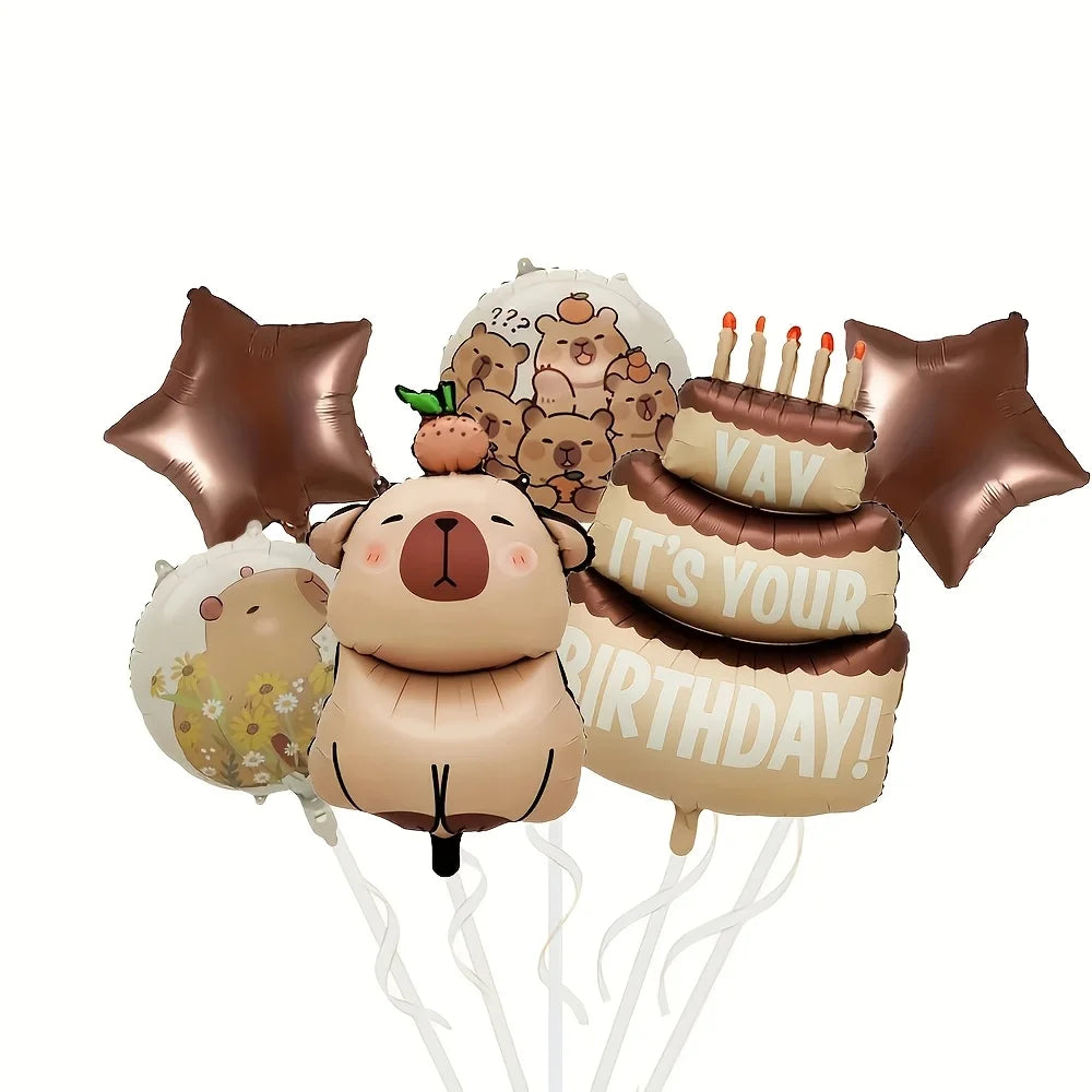 A set of brown foil balloons and a banner featuring capybara faces for a birthday party decoration.