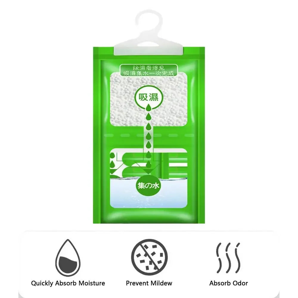 A green hanging moisture absorber bag with labels indicating functions like absorb moisture, prevent mildew, and absorb odor.