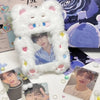 A white fluffy cat plush holder with a zippered opening displaying a photo card.