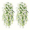 A set of two artificial morning glory and eucalyptus hanging floral decor featuring white flowers and green leaves.