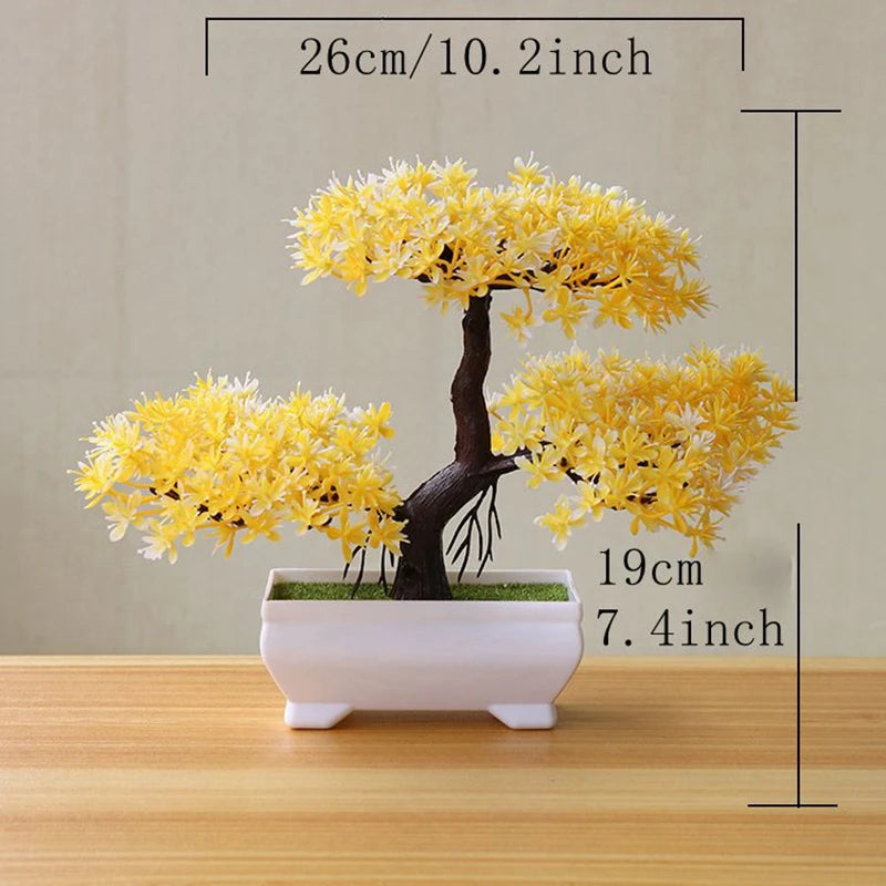 Artificial tree bonsai decoration with bright yellow foliage planted in a white rectangular pot