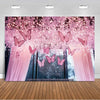 A pink and purple butterfly photo backdrop featuring sheer curtains and sparkling glitter in a forest setting.