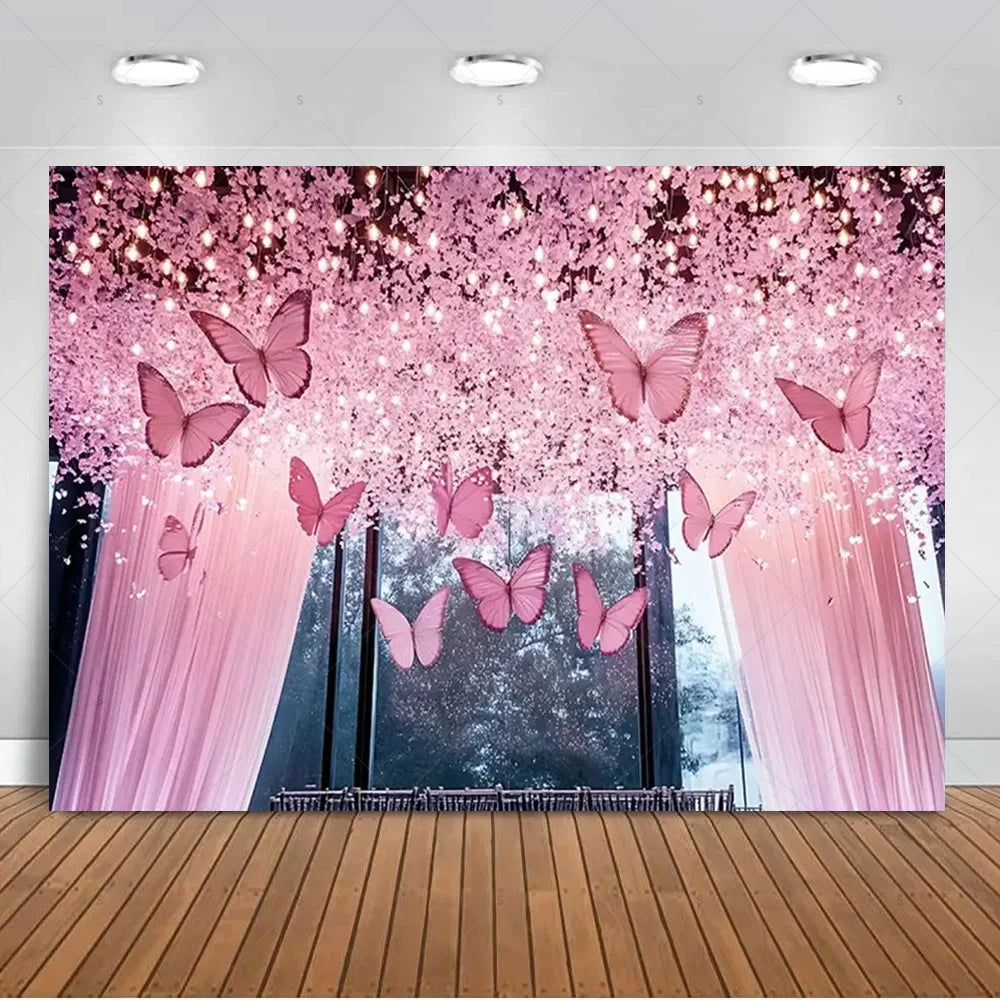 A pink and purple butterfly photo backdrop featuring sheer curtains and sparkling glitter in a forest setting.