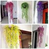 Various artificial plant vines and greenery wall hangings in pink, green, and purple colors