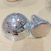 Silver, mushroom-shaped disco ball decoration with a reflective surface.