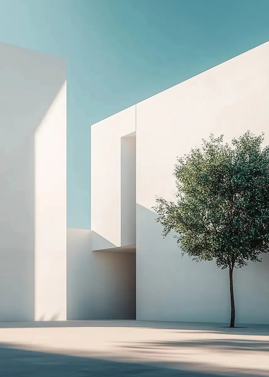 Minimalist white architecture featuring sharp geometric lines and a green tree silhouette against a clear blue sky.