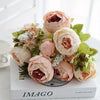 A bouquet of artificial champagne peony flowers in soft peach and blush tones.