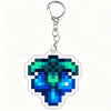 A clear acrylic keychain charm featuring a vibrant teal and blue gemstone design.
