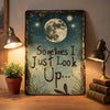Vintage metal wall decor featuring a moon and dragonflies with the quote Sometimes I Just Look Up
