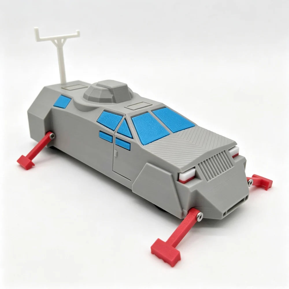 A gray armored car model with blue accents and a white antenna, shown from the side.