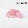 A cluster of pink rose quartz crystals with tiny gold inclusions.