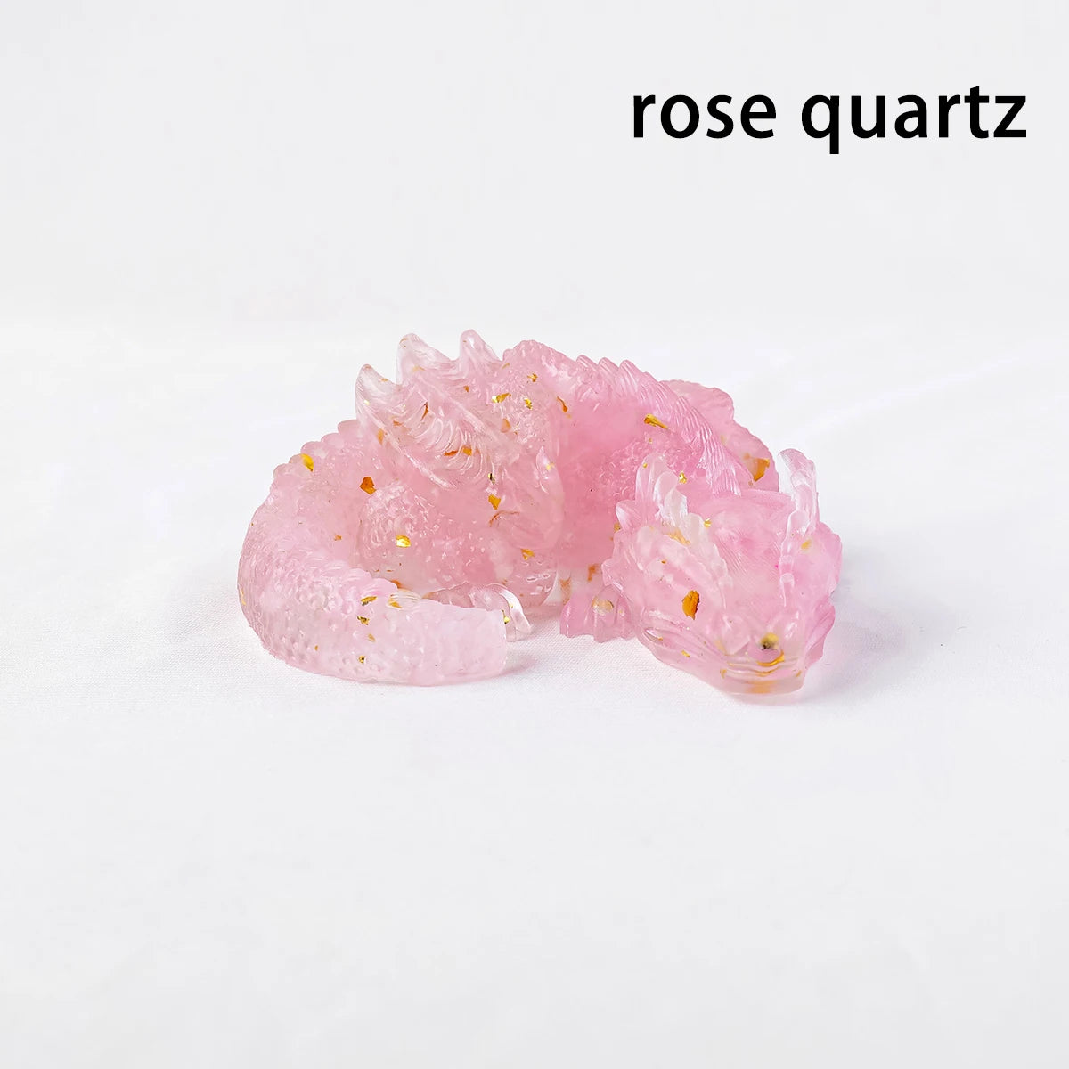 A cluster of pink rose quartz crystals with tiny gold inclusions.