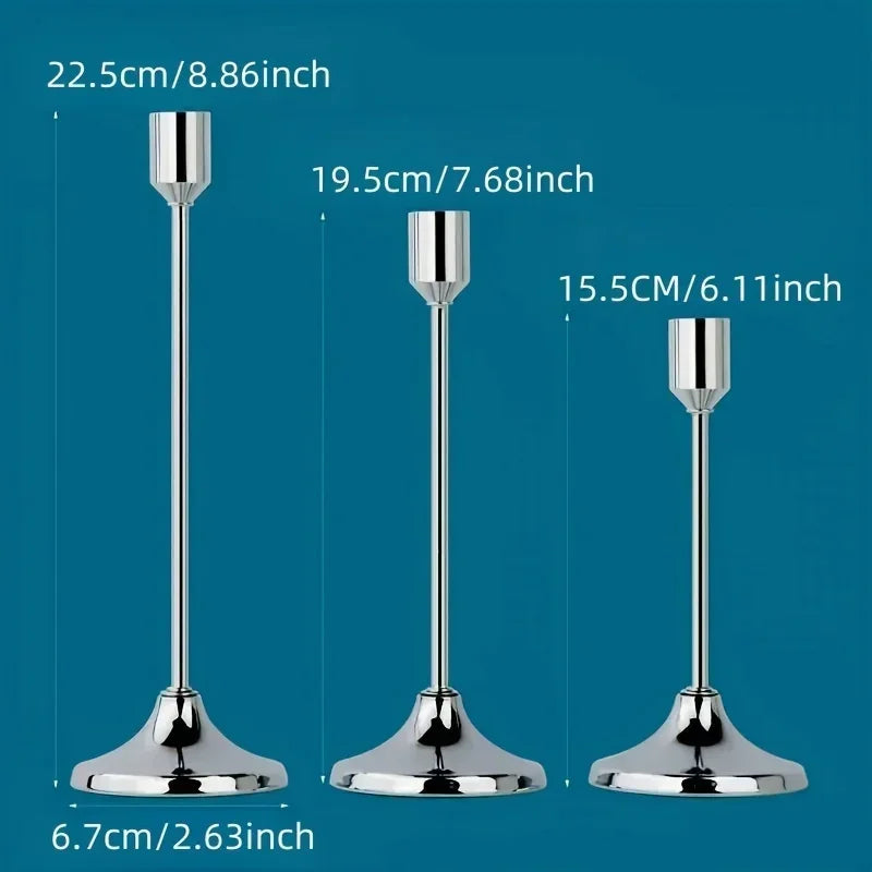 A set of three elegant metal candle holders shown with various heights and bases.