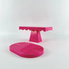 A pink cupcake stand with a ruffled top and a pink circular cake stand on a white background.