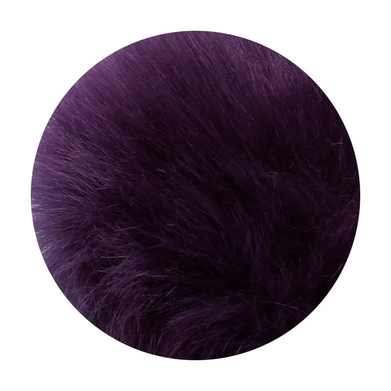 A close-up of a deep purple faux fur pom pom keychain with a silver chain.
