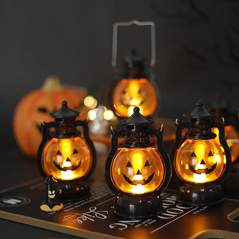 A collection of glowing Halloween LED pumpkin and ghost hanging lanterns displayed on a wooden surface.