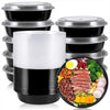A stack of round black meal prep containers with clear lids and one open container filled with various healthy ingredients.