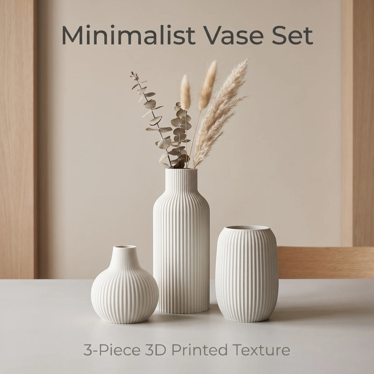 A set of three white ceramic vases with vertical ribbed texture displayed on a light surface.