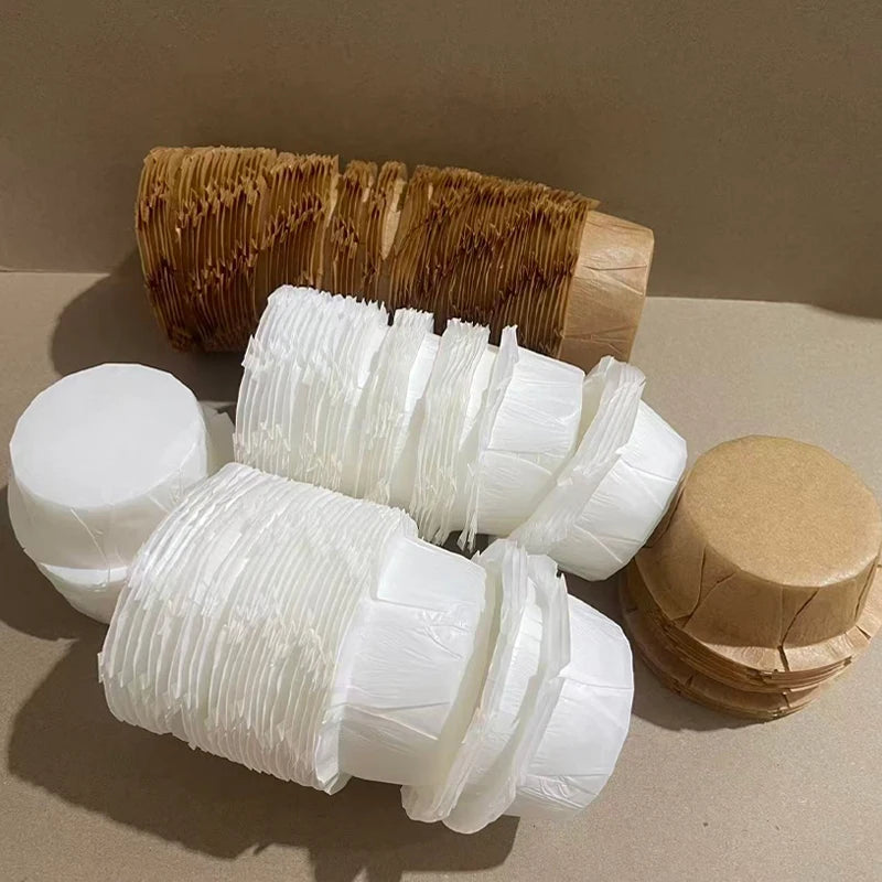 A collection of fluted paper cups in white and brown shades for baking and party decor.