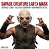 A realistic demon latex mask with sharp teeth and detailed features shown against a white background.
