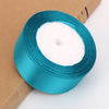 Roll of teal satin ribbon for crafts and gift wrapping