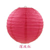 A round, bright pink paper lantern with vertical folds.
