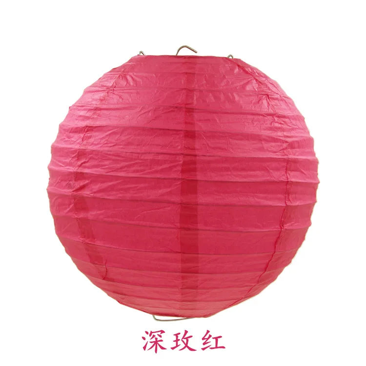 A round, bright pink paper lantern with vertical folds.