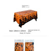 Orange Halloween tablecloth featuring a print of pumpkins, spider webs, and bats.