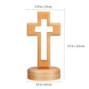 A wooden crucifix wall ornament with a cross mounted on a circular base.