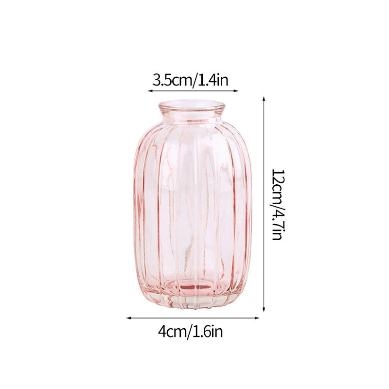A pink textured glass vase with a rounded body and narrow neck, measuring 3.5cm wide and 12cm tall.