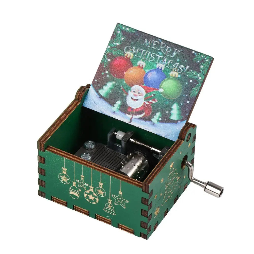 A vintage hand-cranked wooden music box with a green wooden case and a Christmas-themed lid.