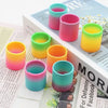 A collection of colorful, stacked silicone cups in rainbow shades for party favors.