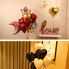 A display of various glitter curling ribbon rolls in shades of pink, red, gold, and silver shaped like hearts and stars for g