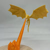 A golden dragon flame light fixture with translucent orange fire effect mounted on a wooden surface.