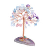 A crystal money tree decor featuring various translucent and colored quartz crystals branching from a pink stand.