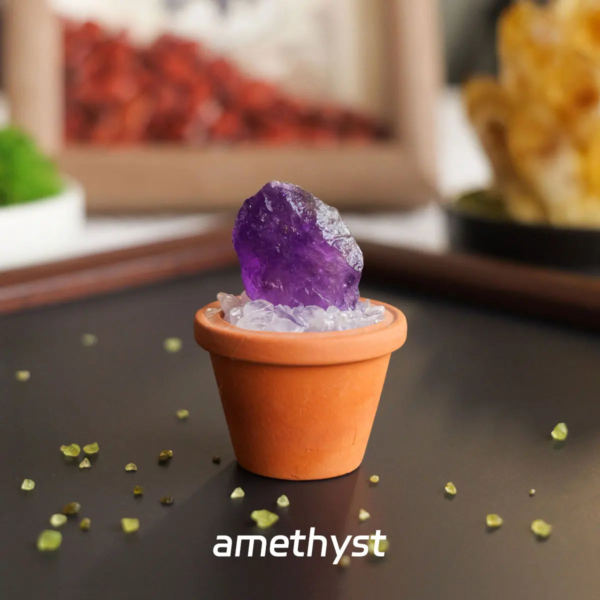 A purple amethyst crystal sits in an orange pot on a dark surface.